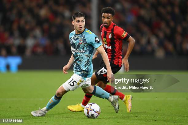 Romain Perraud of Southampton runs with the ball whilst under pressure from Junior Stanislas of AFC Bournemouth during the Premier League match...