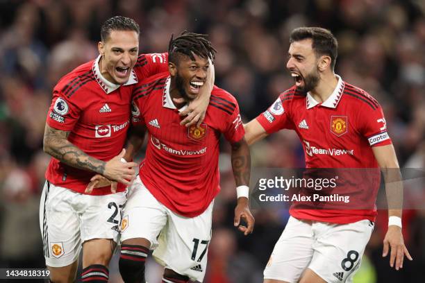 Fred of Manchester United celebrates with team mates Antony and Bruno Fernandes after scoring their sides first goal during the Premier League match...