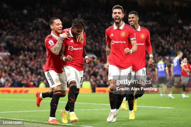 Fred of Manchester United celebrates with team mates Antony and Bruno Fernandes after scoring their sides first goal during the Premier League match...