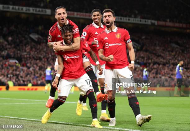 Fred of Manchester United celebrates with team mates Antony and Bruno Fernandes after scoring their sides first goal during the Premier League match...