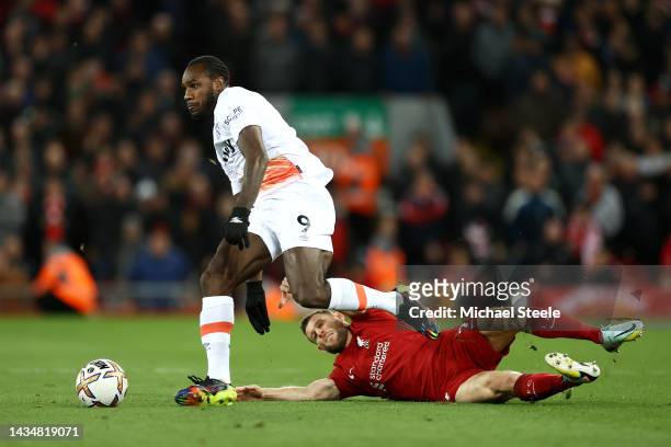 Michail Antonio of West Ham United is challenged by James Milner of Liverpool during the Premier League match between Liverpool FC and West Ham...