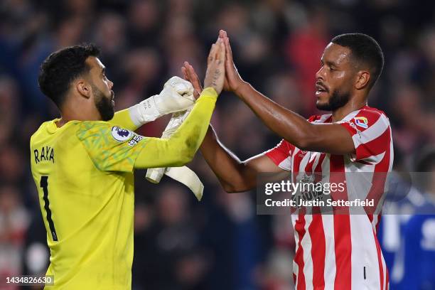 David Raya embraces Mathias Zanka Jorgensen of Brentford after their sides draw during the Premier League match between Brentford FC and Chelsea FC...