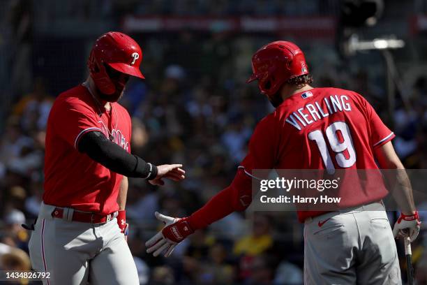 Bryce Harper celebrates with Matt Vierling of the Philadelphia Phillies after scoring a run during the second inning against the San Diego Padres in...