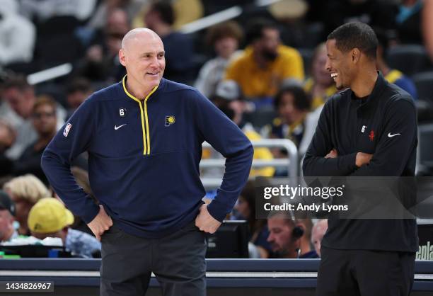 Rick Carlisle the head coach of the Indiana Pacers and Stephen Silas the head coach of the Houston Rockets share a laugh during the game at...