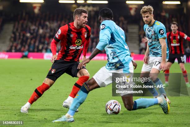 Ainsley Maitland-Niles and Stuart Armstrong of Southampton close down Joe Rothwell of Bournemouth during the Premier League match between AFC...
