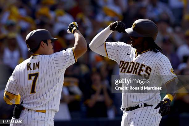 Josh Bell of the San Diego Padres celebrates with Ha-Seong Kim after hitting a solo home run during the second inning against the Philadelphia...