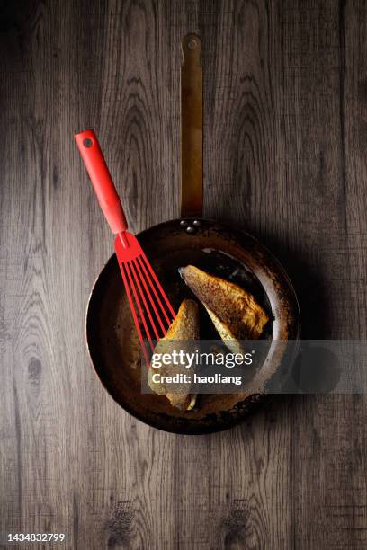 pan fried sea bass fillets - spatula stock pictures, royalty-free photos & images