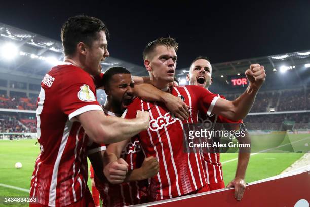 Matthias Ginter of SC Freiburg celebrates scoring their side's first goal with teammates during the DFB Cup second round match between Sport-Club...
