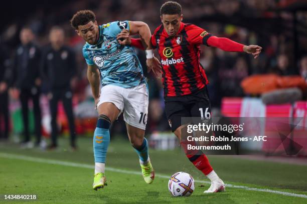 Che Adams of Southampton and Marcus Tavernier of Bournemouth fight for the ball during the Premier League match between AFC Bournemouth and...
