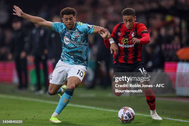 Che Adams of Southampton and Marcus Tavernier of Bournemouth fight for the ball during the Premier League match between AFC Bournemouth and...