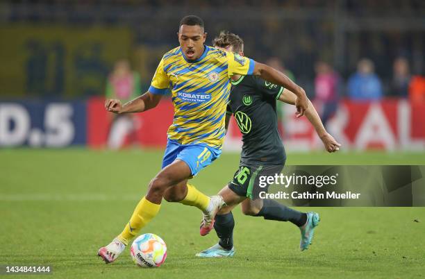 Anton Donkor of Eintracht Braunschweig is challenged by Jakub Kaminski of VfL Wolfsburg during the DFB Cup second round match between Eintracht...