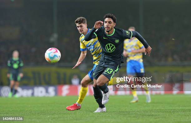 Omar Marmoush of VfL Wolfsburg is challenged by Danilo Wiebe of Eintracht Braunschweig during the DFB Cup second round match between Eintracht...