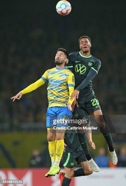 Fabio Kaufmann of Eintracht Braunschweig and Felix Nmecha of VfL Wolfsburg battle for the ball during the DFB Cup second round match between...