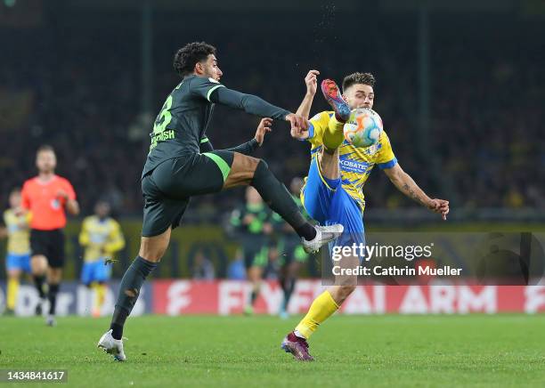 Omar Marmoush of VfL Wolfsburg and Maurice Multhaup of Eintracht Braunschweig battle for the ball during the DFB Cup second round match between...