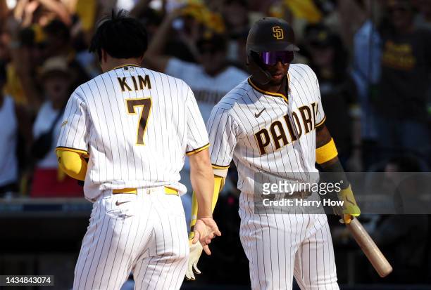 Ha-Seong Kim of the San Diego Padres celebrates with Jurickson Profar after scoring a run on a RBI single hit by Austin Nola during the fifth inning...