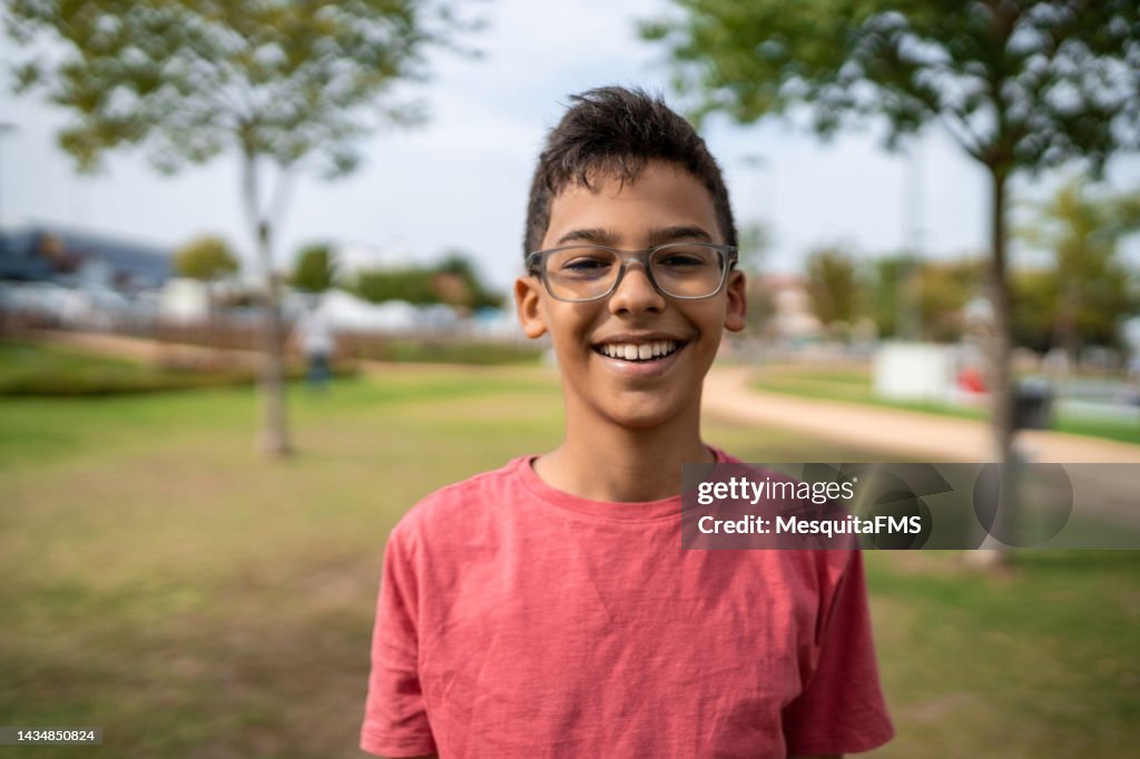 Portrait of boy laughing in public square