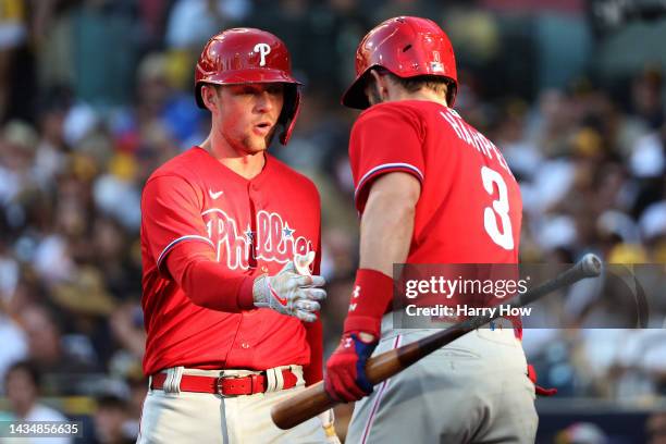 Rhys Hoskins of the Philadelphia Phillies celebrates with Bryce Harper after hitting a solo home run during the eighth inning against the San Diego...