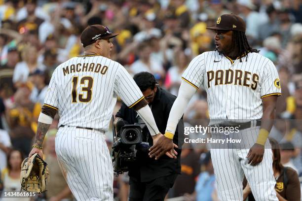 Manny Machado of the San Diego Padres and Josh Bell celebrate defeating the Philadelphia Phillies 8-5 in game two of the National League Championship...