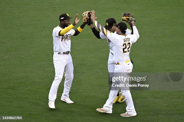 Jurickson Profar, Trent Grisham and Juan Soto of the San Diego Padres celebrate defeating the Philadelphia Phillies 8-5 in game two of the National...