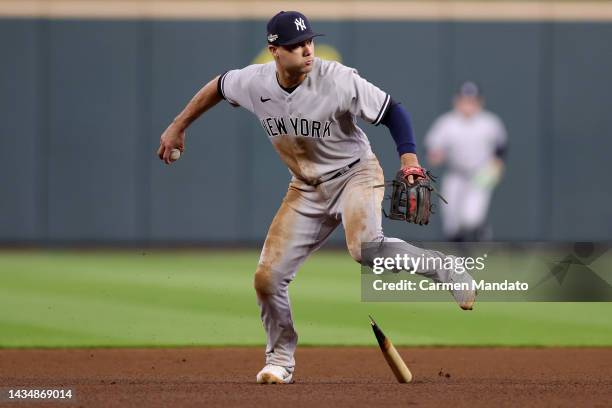 Isiah Kiner-Falefa of the New York Yankees fields the ball and avoids the broke bat of Martin Maldonado of the Houston Astros during the fourth...