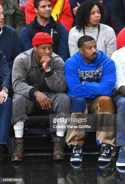 Jonathan Majors and Michael B. Jordan attend the season home opener game between the Houston Rockets and the Atlanta Hawks at State Farm Arena on...