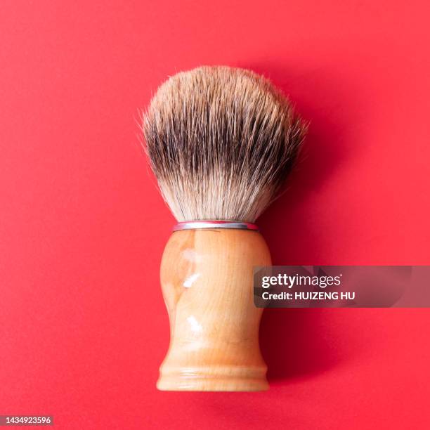 wooden shave brush on a red background - wood shaving stock pictures, royalty-free photos & images