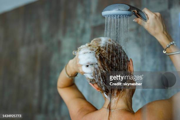 washing hair with shampoo! - women taking showers stock pictures, royalty-free photos & images