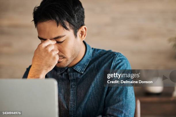 stress, burnout and frustrated business man at laptop suffering from headache, migraine and depression at his desk. depression and anxiety of male entrepreneur upset after mistake or slow internet - managing uncertainty stock pictures, royalty-free photos & images