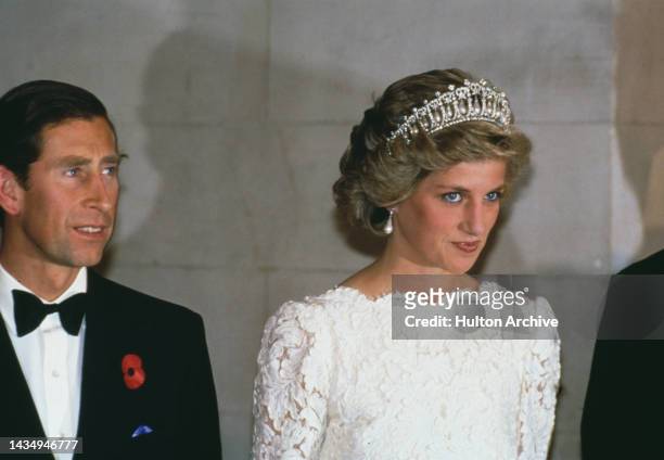 Princess Diana wearing a white evening dress and the Queen Mary tiara at a visit to the British Embassy in Washington with Prince Charles on November...