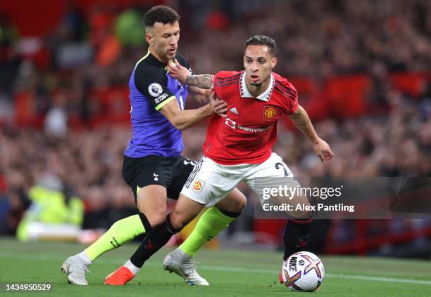 Antony of Manchester United holds of pressure from Ivan Perisic of Tottenham during the Premier League match between Manchester United and Tottenham...