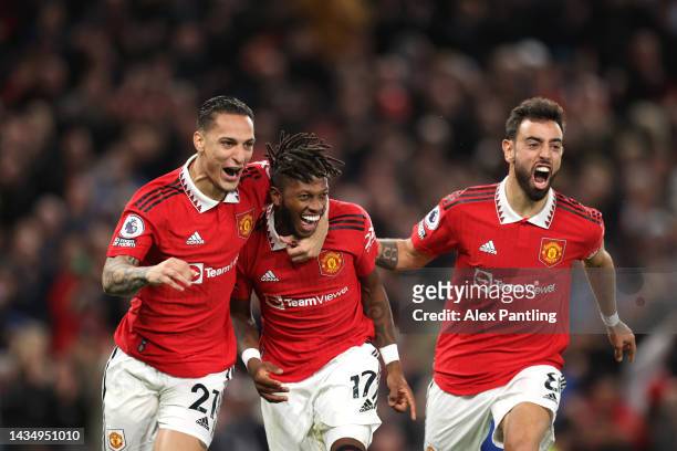 Fred of Manchester United celebrates with team mates Antony and Bruno Fernandes after he scores his sides first goal during the Premier League match...