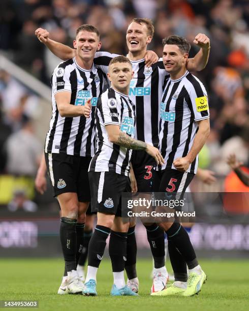 Sven Botman, Kieran Trippier, Dan Burn and Fabian Schar of Newcastle United celebrate their side's win after the final whistle of the Premier League...