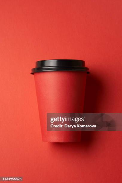 the paper red cup for hot drinks on isolated red background. mockup for your design. design element with copy space. - coffee cup stock pictures, royalty-free photos & images