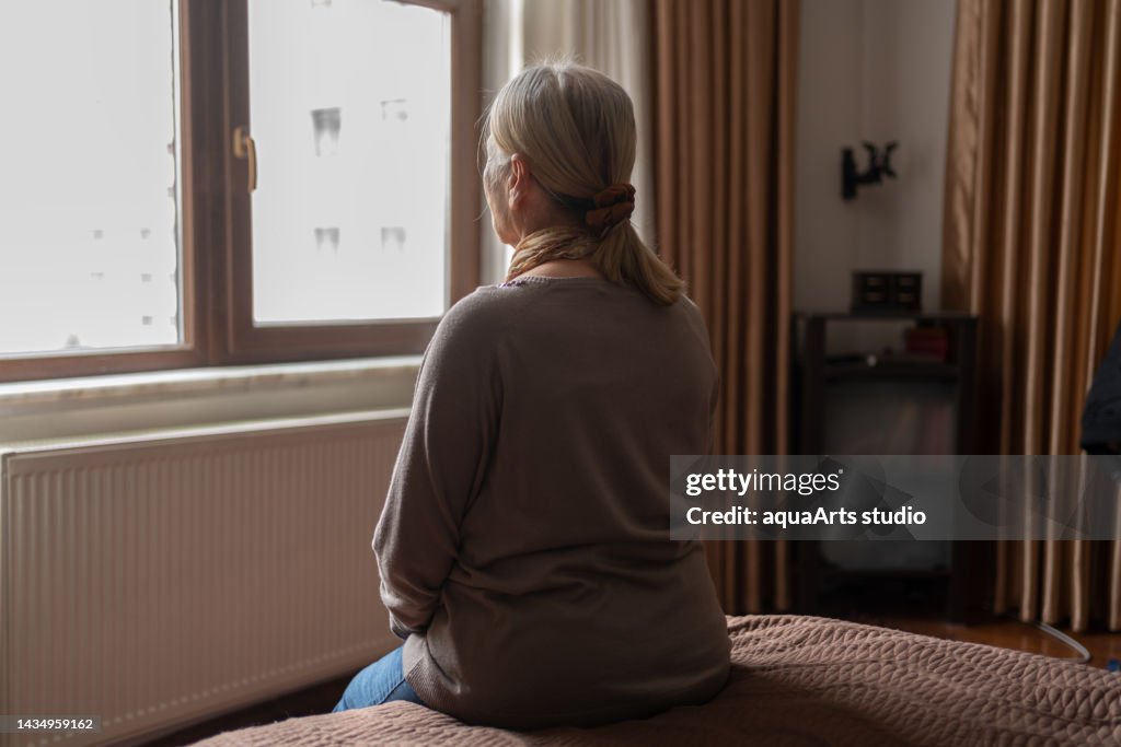 Senior Woman Looking Out The Window