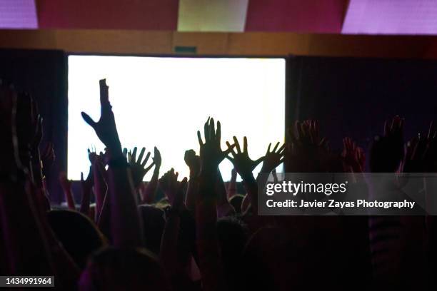 crowd silhouette at a performance - hand back lit stock pictures, royalty-free photos & images