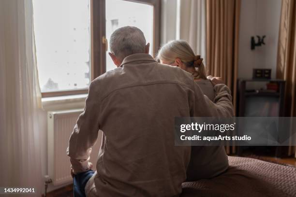 contemplative senior couple at home - demens bildbanksfoton och bilder