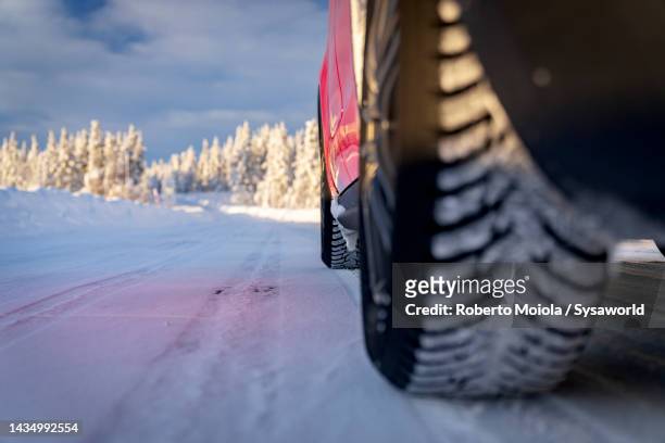 winter tires of car on a snowy road, sweden - car scandinavia stock pictures, royalty-free photos & images