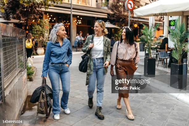female friends exploring city together - female friendship stock pictures, royalty-free photos & images