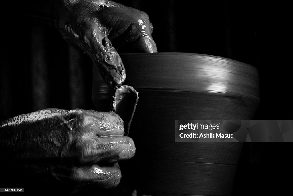 Potter making pot