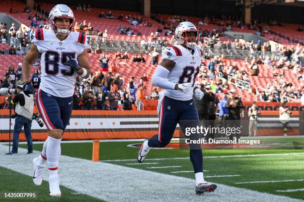 Jonnu Smith and Hunter Henry of the New England Patriots run onto the field prior to a game against the Cleveland Browns at FirstEnergy Stadium on...