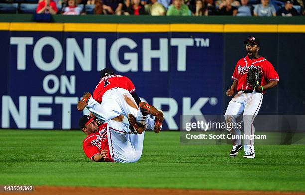 Dan Uggla of the Atlanta Braves collides with Tyler Pastornicky after making a diving catch against the Pittsburgh Pirates at Turner Field on April...