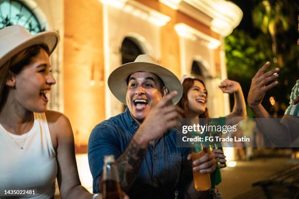 friends talking outdoors at night - street party stock pictures, royalty-free photos & images