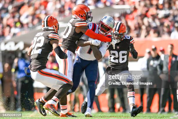 DeVante Parker of the New England Patriots is tackled by Jacob Phillips and Greedy Williams of the Cleveland Browns during the first half at...