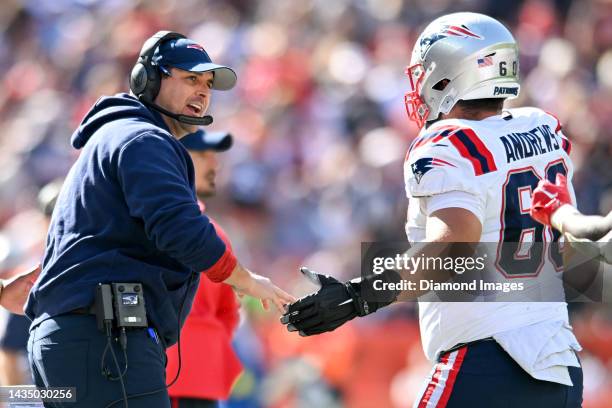 Offensive assistant/quarterbacks coach Joe Judge of the New England Patriots celebrates a touchdown drive with David Andrews during the first half...