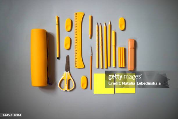 school supplies yellow on grey background - yellow pencil stock pictures, royalty-free photos & images