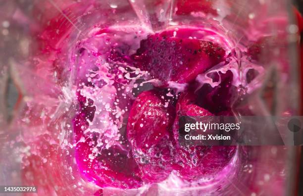 dragon fruit pitaya under high speed blending synced in high speed photography - liquidiser stock pictures, royalty-free photos & images