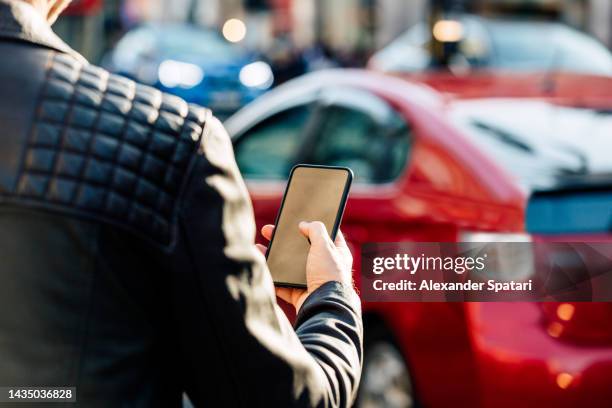 man using smartphone on the street, close-up - car pooling stock pictures, royalty-free photos & images