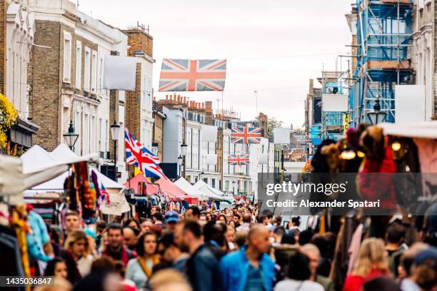 crowds of people at portobello road market in notting hill, london, uk - notting hill photos et images de collection