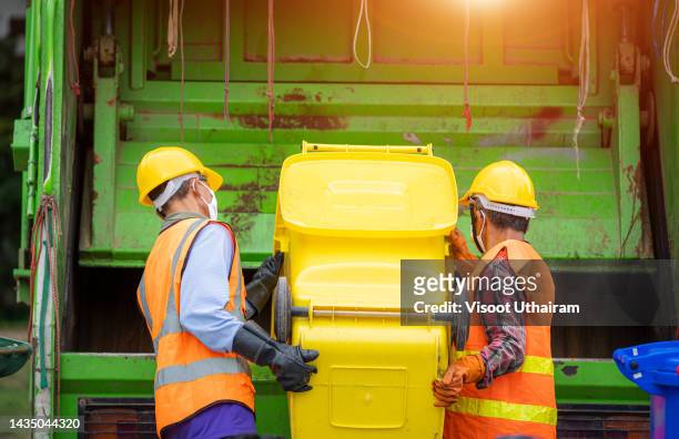 garbage man collector,garbage removal. - dustbin lorry stock pictures, royalty-free photos & images