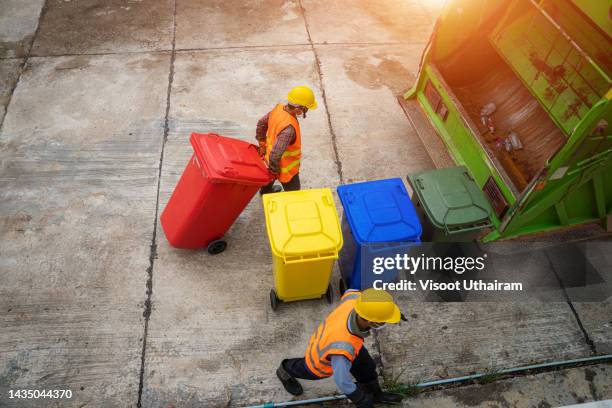 rubbish cleaner man are loading garbage in the garbage truck,garbage collector. - garbage truck stock-fotos und bilder